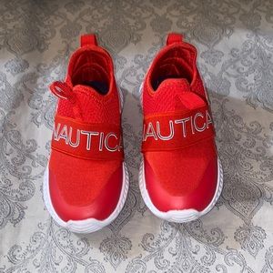 Red and white Nautica toddler sneakers.